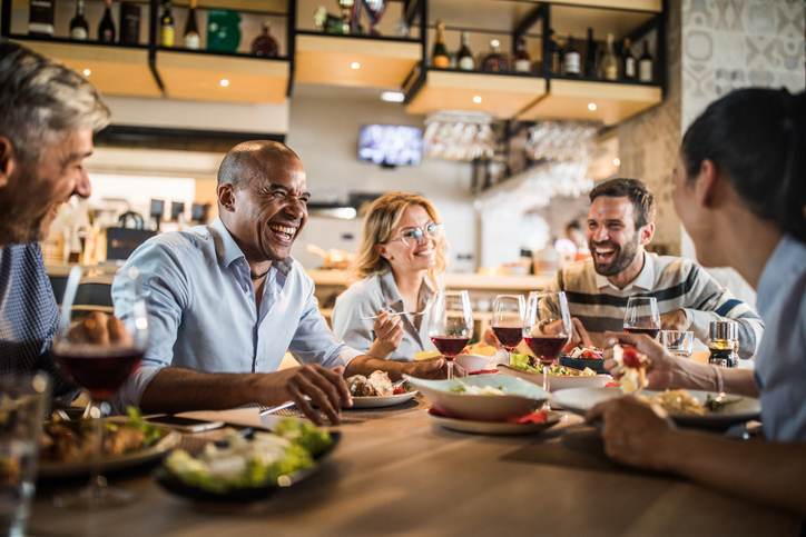 Group of cheerful business people having fun on a lunch.