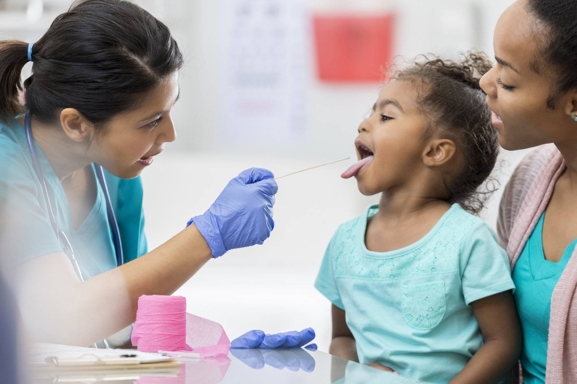 Doctor examines young African American patient Doctor examines young African American patient
