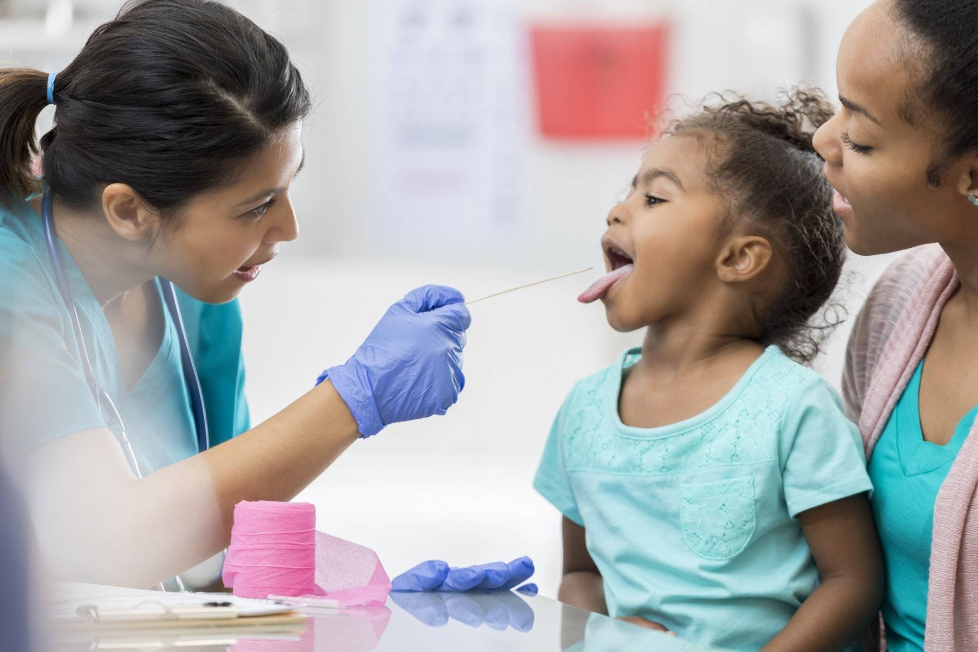 Doctor examines young African American patient